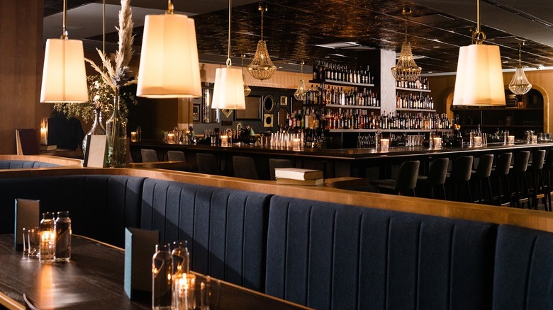 Blue velvet banquettes inside Nashville whiskey bar