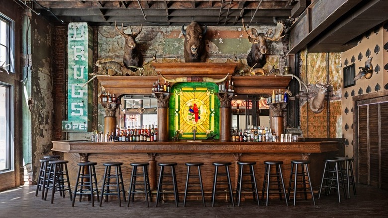 Rustic wooden bar with taxidermy deer and buffalo heads