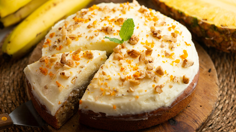 Hummingbird cake topped with chopped pecans and orange zest