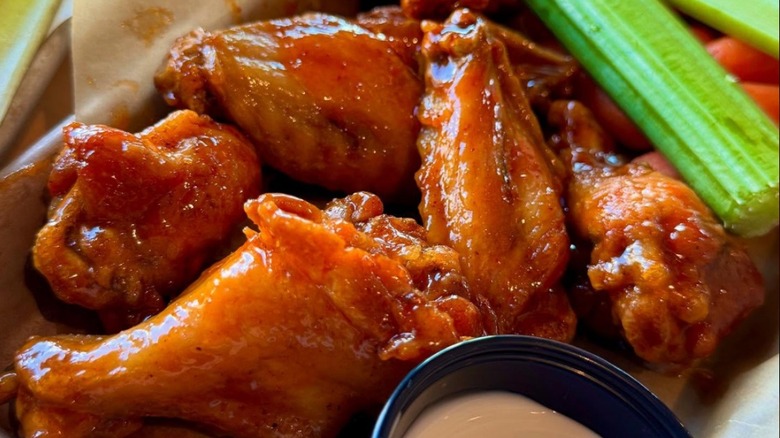 A plate of wings from Buffalo Wild Wings with celery sticks on the side