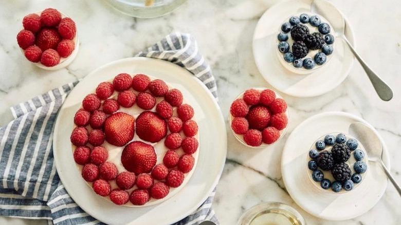 Berry desserts with white frosting by Tatte Bakery & Café on a marble table