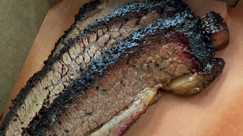Juicy sliced brisket with a deep dark bark and rich red smoke ring