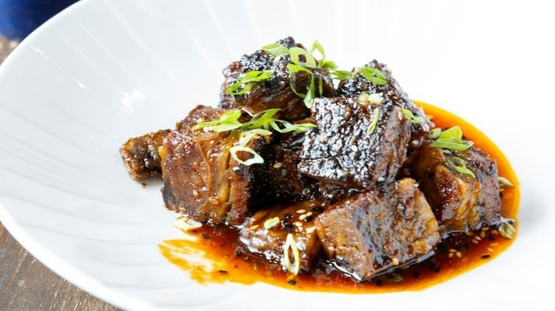An elegantly plated serving of brisket burnt ends