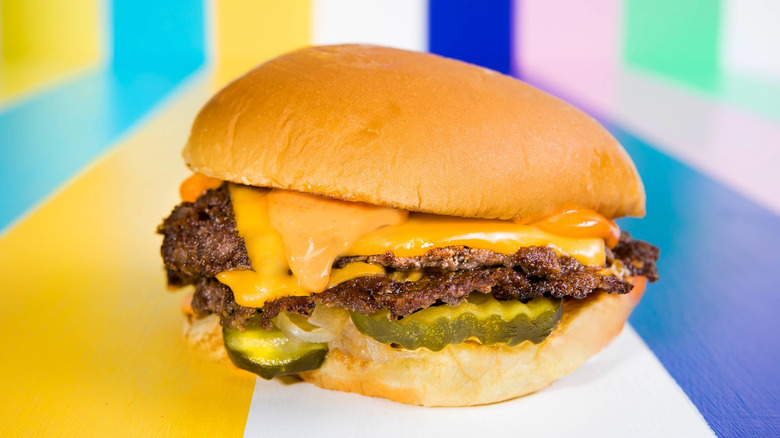 The Classic Moonlit Double from Moonlit Burgers on a rainbow backdrop