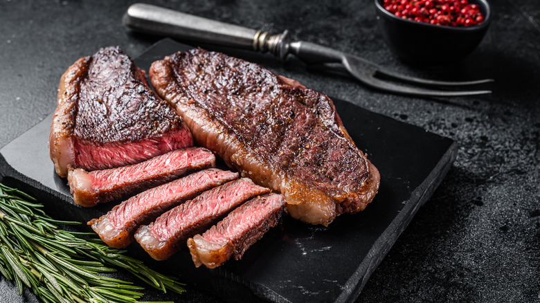 Medium-rare top sirloin on black marble cutting board