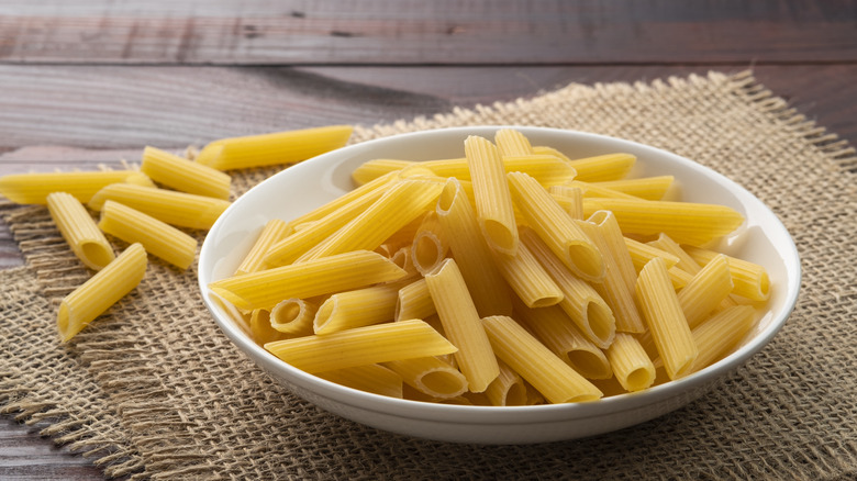 Penne pasta uncooked in a bowl