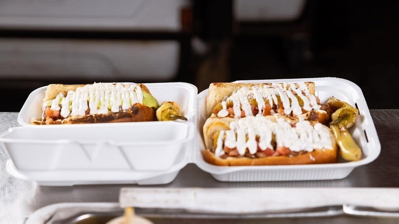Three hot dogs in Styrofoam containers