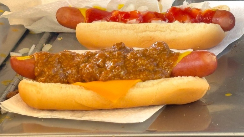 A chili dog and hot dog with ketchup