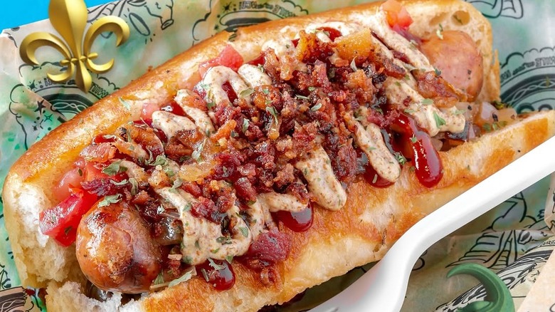 An alligator hot dog covered in toppings