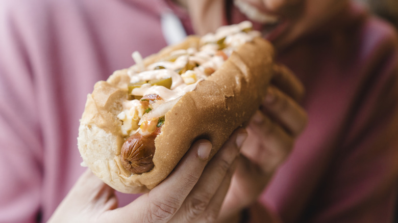 A person eating a hot dog