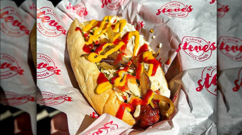 A hot with assorted toppings, ketchup, and mustard