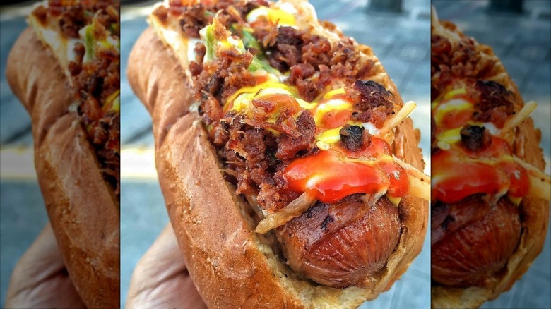 A hot dog covered in toppings