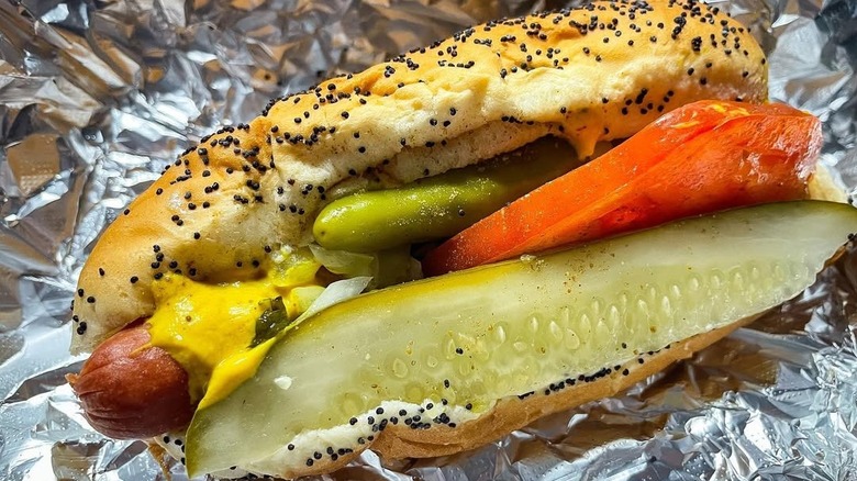 A Chicago-style hot dog in tin foil