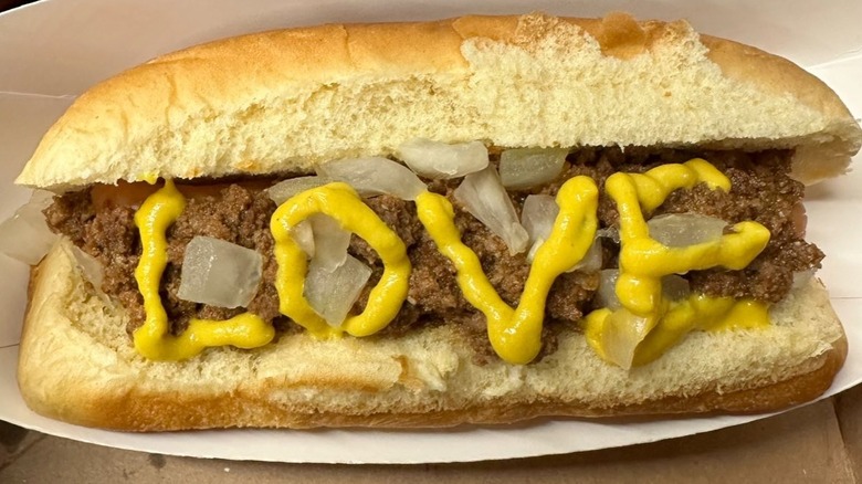 A hot dog with the word 'love' written in mustard