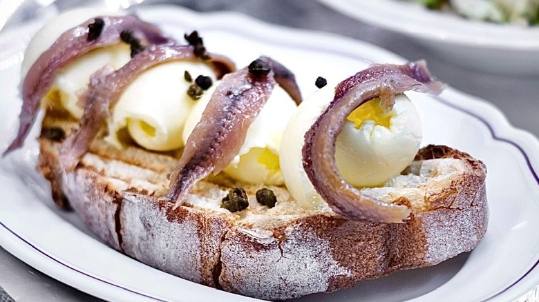 A plate of anchovies and quail eggs on toast at Via Carota in New York City