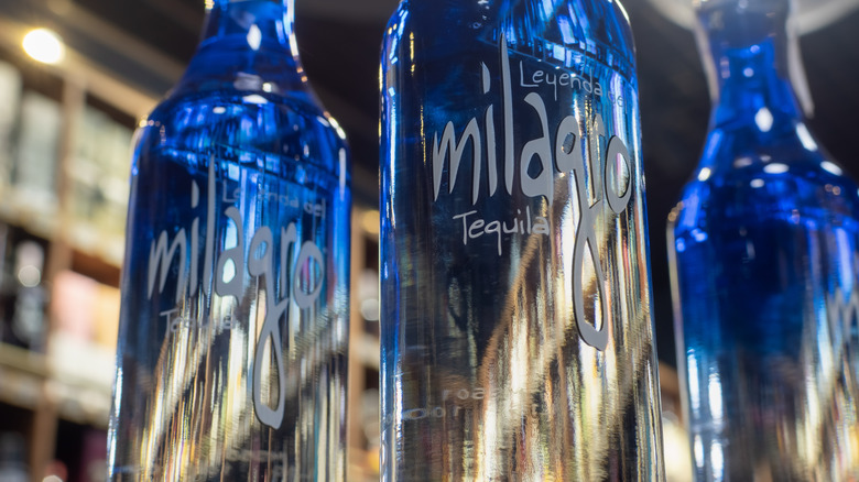 Milagro blue and silver tequila bottle close up