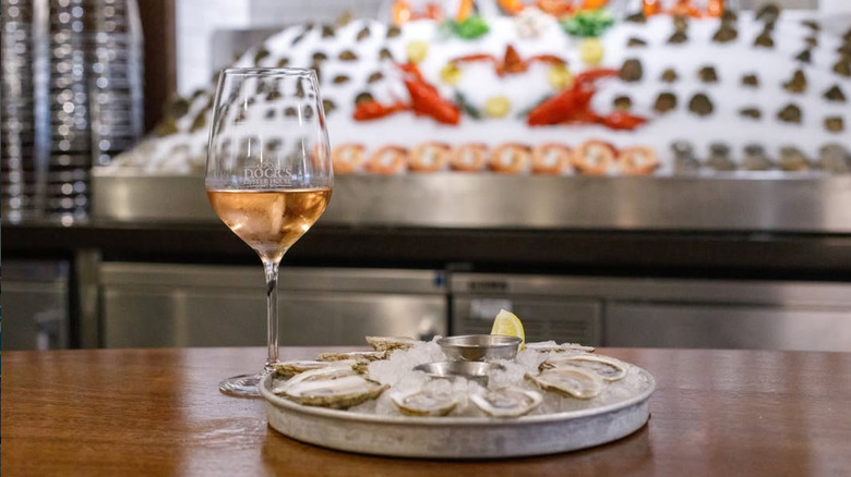 A plate of oysters and a glass of wine at Dock's Oyster House