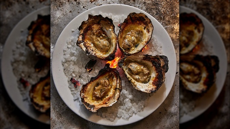 BBQ oysters on a round, white plate at Oyster House