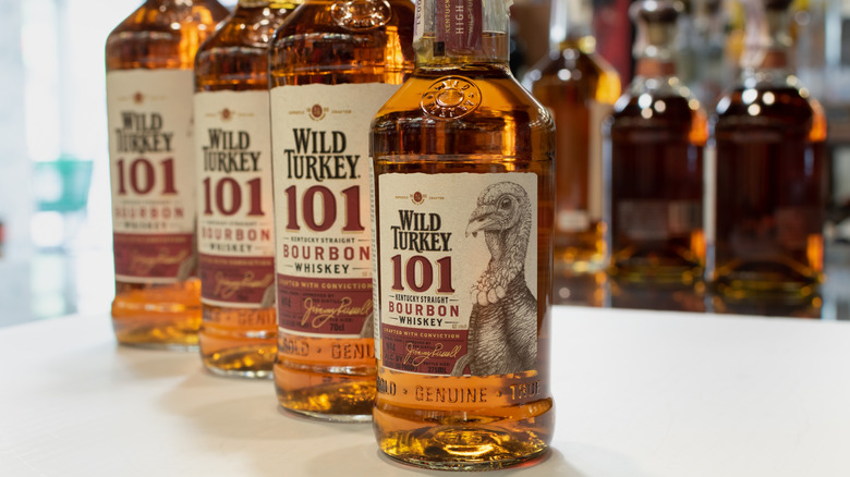 Four bottles of Wild Turkey 101 (perfectly acceptable for drinking or marinating) lined up on a counter.