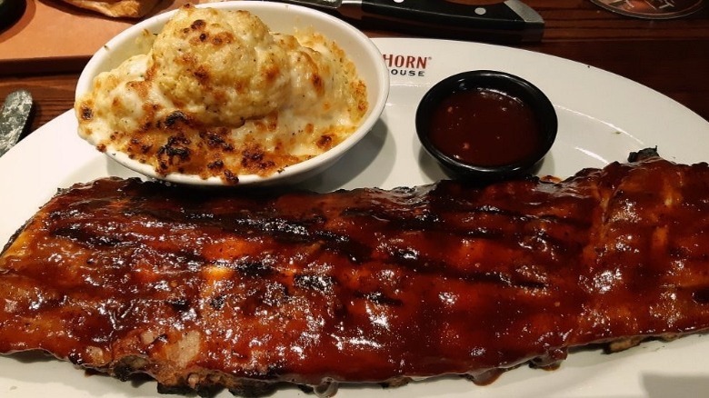 Barbecue ribs with mac and cheese on a plate at a Longhorn Steakhouse restaurant.