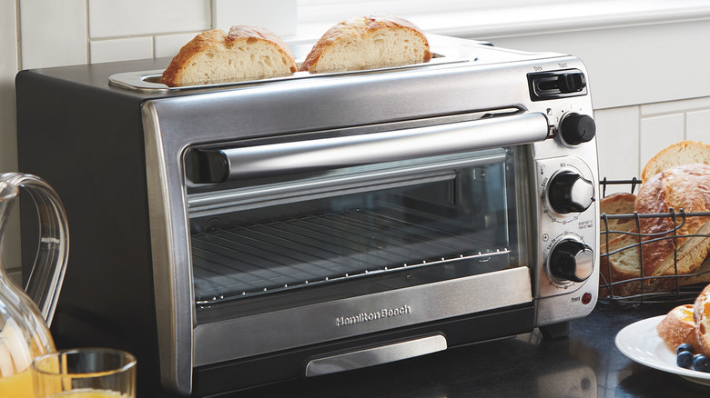 A Hamilton Beach Toaster Oven on a kitchen counter with toast in the toaster
