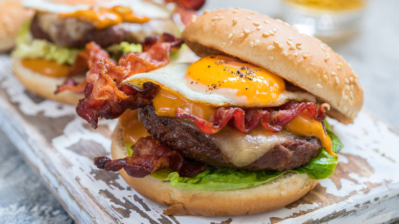 burgers with bacon, cheese, and a fried egg