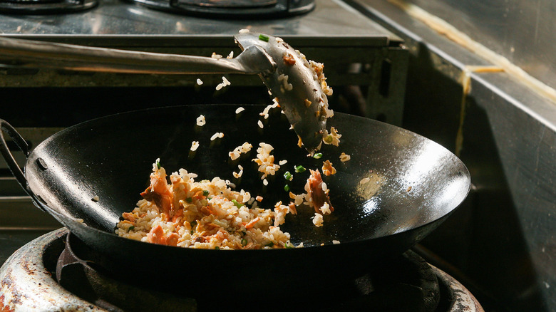 Fried rice being cooked in a wok.
