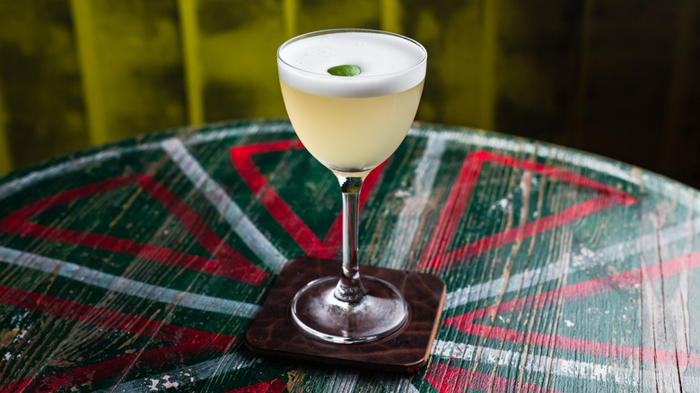 classic yellow sour cocktail in a nick and nora glass