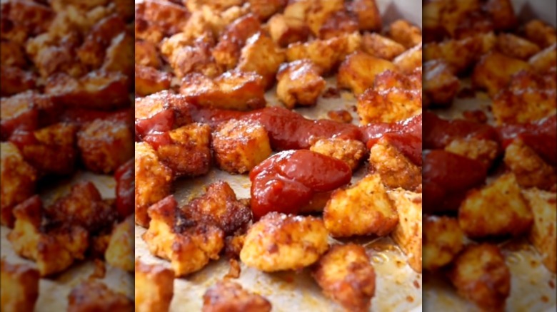 Marinated BBQ tofu with sauce on a sheet pan