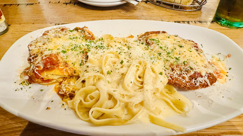 Olive Garden's Tour of Italy entree featuring fettuccine Alfredo, lasagna, and chicken Parm