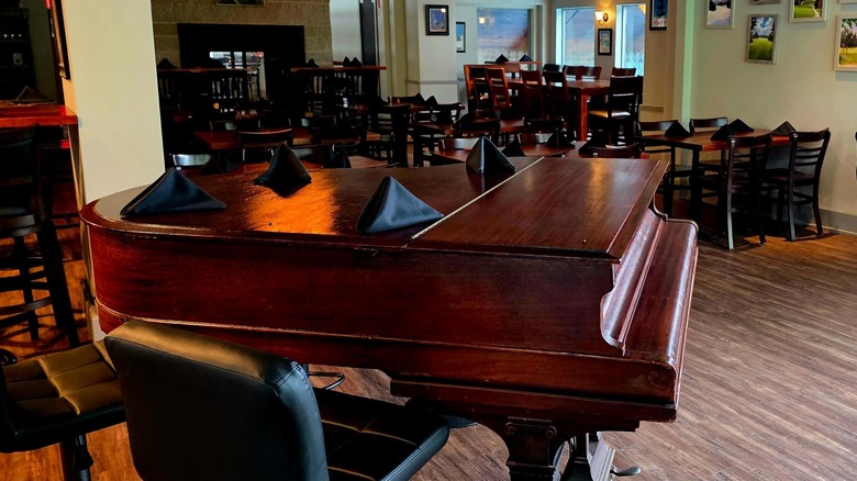 Piano in and dining room of The Wine Bar
