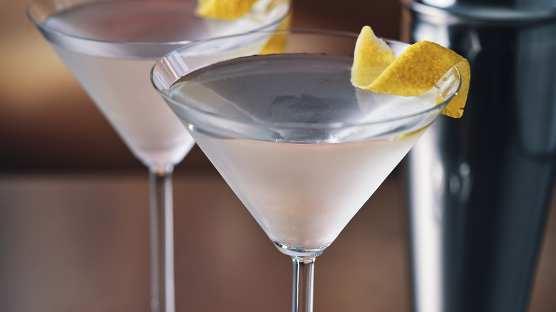 Two martinis with lemon zest garnish
