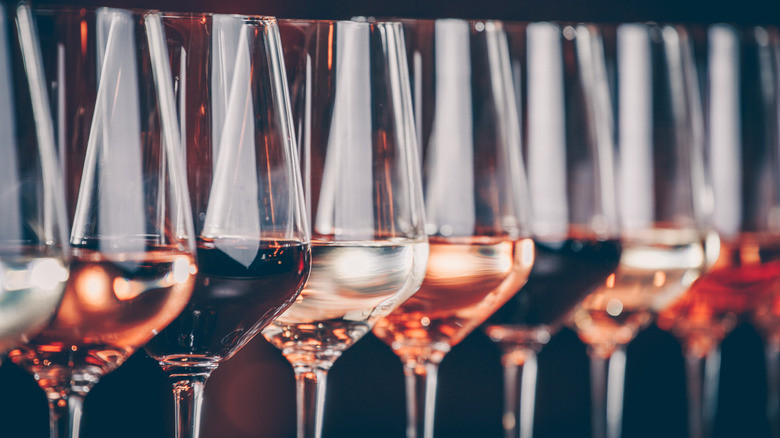 Different types of wine in a row of wine glasses