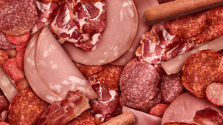 A mixed variety of cured and processed deli meats.