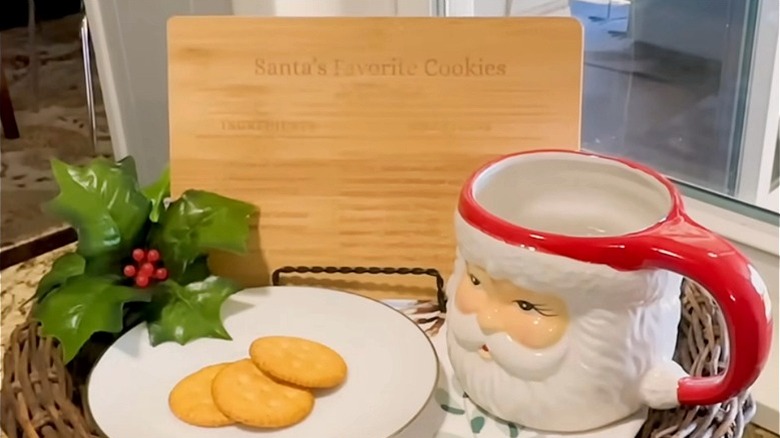 Recipe bamboo cutting board next to Santa mug.