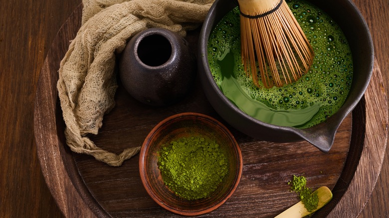 Matcha powder and matcha being whisked