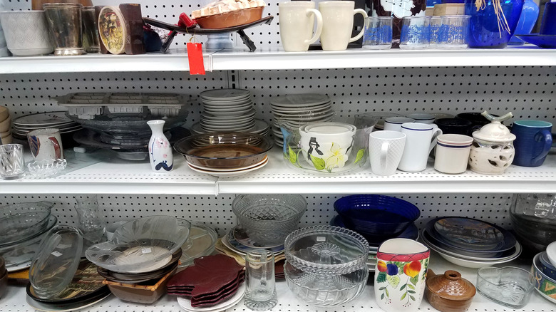 dishes displayed on shelves at a thrift store