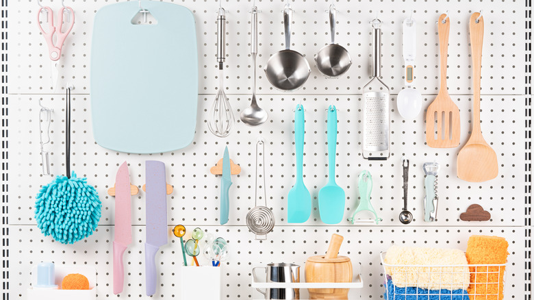 Pegboard wall holding essential kitchen tools