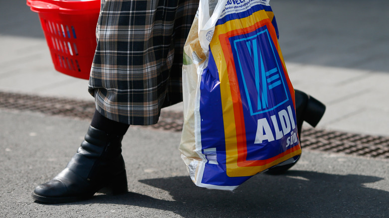 Person carrying an aldi shopping bag