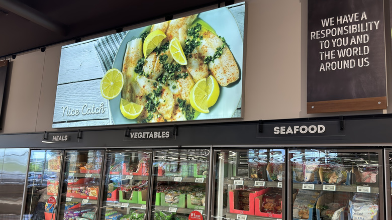 Aldi grocery store seafood section with a sign saying 'We have a responsibility to you and the world around us'