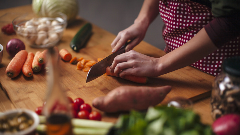 Person chopping vegetables in the kitchen