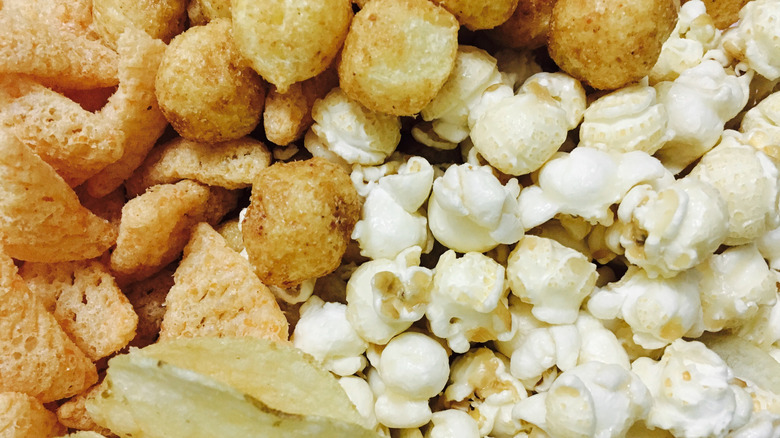 Popcorn, pork rinds, and other snacks in a pile