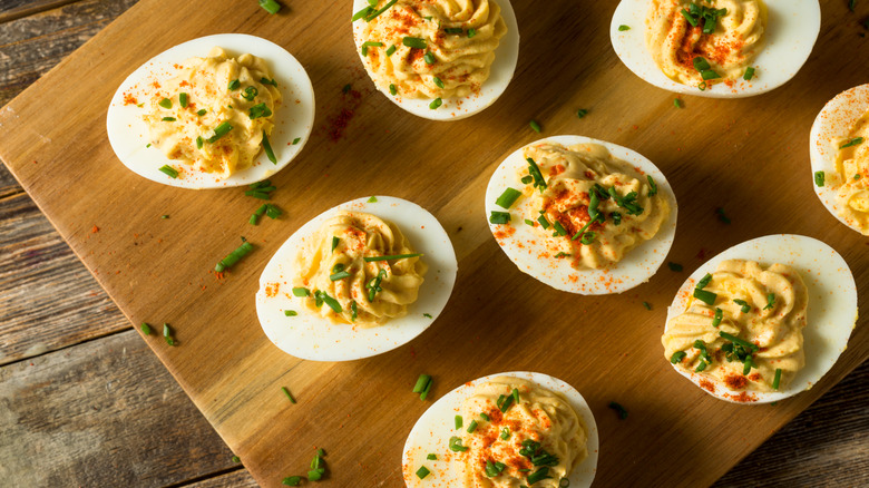Deviled eggs on a wooden board