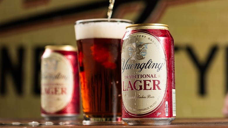 Can of Yuengling Traditional Lager with a poured glass of the same beer beside it