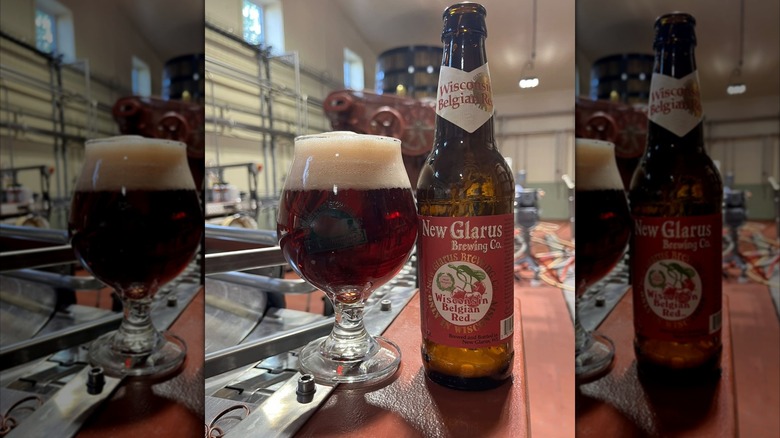 Bottle of Wisconsin Belgian Red with a glass of poured beer beside it