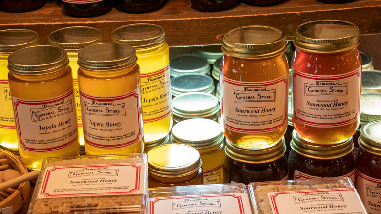 Jars of sourwood and tupelo honey for sale.