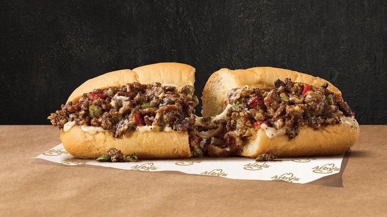 Arby's cheesesteak sandwich sitting atop its wrapper