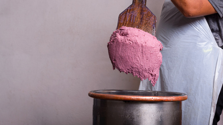 Small batch ice cream is scooped out with a paddle for hand packing.