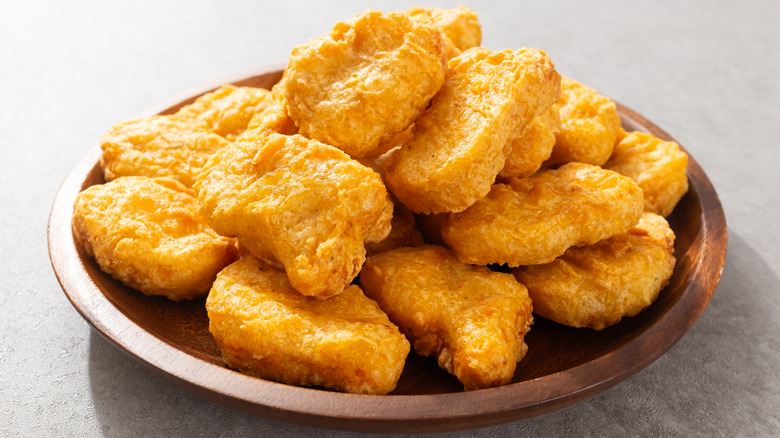 Chicken nuggets on a wooden plate