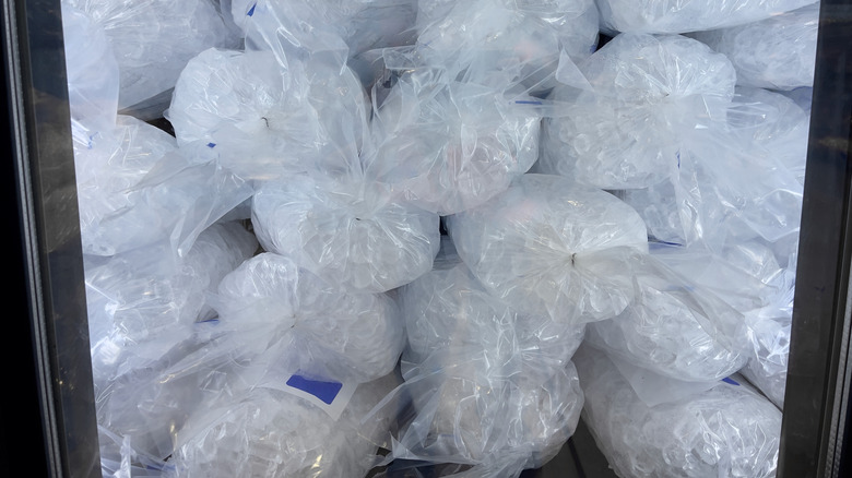 Bags of ice in grocery store freezer